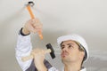 Man hammering ceiling Royalty Free Stock Photo