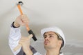 Man hammering concrete ceiling Royalty Free Stock Photo