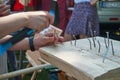 Man hammering a nail into a block of hard wood Royalty Free Stock Photo