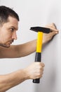 Man hammering nail into wall Royalty Free Stock Photo