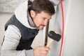 Man hammers nail with hammer Royalty Free Stock Photo