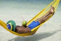 Man in Hammock Brazilian Beach with Coconut