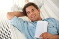 Man in hammock , portrait and smile, reading book and relax, vacation and learning with self care and time alone Royalty Free Stock Photo