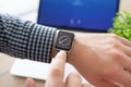 Man hand with Apple Watch and Macbook on the desk Royalty Free Stock Photo