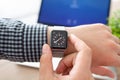 Man hand with Apple Watch and Macbook on the desk Royalty Free Stock Photo