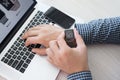 Man hand with Apple Watch and Macbook on the desk Royalty Free Stock Photo