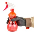 Man hand in black protective glove and brown uniform holding red transparent plastic spray bottle isolated on white background Royalty Free Stock Photo