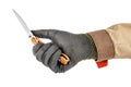 Man hand in black protective glove and brown uniform opens blade of pocket knife with bright orange handle isolated on white Royalty Free Stock Photo