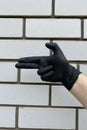 Man hand in black protective glove showing gun gesture Royalty Free Stock Photo