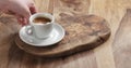 Man hand bring espresso on wood table