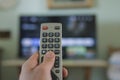 Man hand while browse smart tv app,zapping channels on leisure time,tech lifestyle