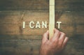 Man hand building the wall between letters I CAN'T Royalty Free Stock Photo