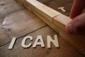 Man hand building the wall between letters I CAN'T, cutting the Royalty Free Stock Photo