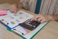 Man hand with calculator at workplace office. A businessman doing some paperwork using his calculator Royalty Free Stock Photo