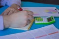 Man hand with calculator at workplace office. A businessman doing some paperwork using his calculator Royalty Free Stock Photo