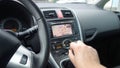 Man hand changing manual gearbox lever - dual climate - ac vents and navigation display