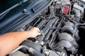 A man hand checking car engine