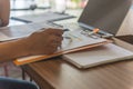 Man hand checking financial number with pen in the office