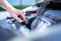 Man hand checking level of coolant car engine. Check and maintenance the coolant in car with yourself