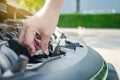 Man hand checking level of coolant car engine. Check and maintenance the coolant in car with yourself Royalty Free Stock Photo