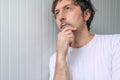 Man with hand on chin thinking deep thoughts Royalty Free Stock Photo