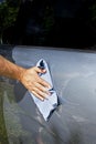 Man hand cleaning car with microfiber cloth Royalty Free Stock Photo