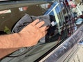 Man hand cleaning car with microfiber cloth at car wash Royalty Free Stock Photo