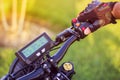 Man hand clicking on control button rear stop signal of electric bicycle Royalty Free Stock Photo