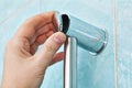 Man hand closes cover fastening bracket holder shower slide rai