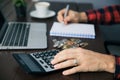 Man hand coins with notepad and calculator