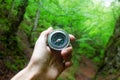Man hand compass in forest