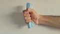 Man hand compressing a face mask