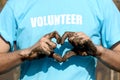 Man hand covered mud dirty do heart shape on blue volunteer t-shirt, after planting sapling tree in deep mud at mangrove forest, Royalty Free Stock Photo