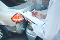 Man hand documant and car crash accident. Royalty Free Stock Photo