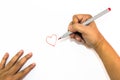 Man hand is drawing heart sign with red marker pen Royalty Free Stock Photo