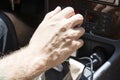 Man hand drivin in a car
