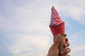 man hand eating ice Chocolate, vanilla and pistachio Ice cream in cone on the sky with city background Royalty Free Stock Photo