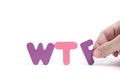 Man hand exposes abbreviation wtf in letters white background. Royalty Free Stock Photo