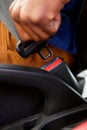 Man hand fastening a seat belt in the car Royalty Free Stock Photo