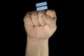 Man hand fist with Botswanan flag isolated on black