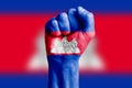 Man hand fist of CAMBODIA flag painted. Close-up.