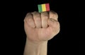 Man hand fist with Malian flag isolated on black background