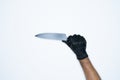 A man hand and gestures in Black rubber glove shows knife isolated on white background Royalty Free Stock Photo