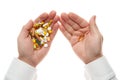 Man hand getting one pill from handful of pills, tablets, vitamins, drugs, capsules isolated on white background. White shirt, Royalty Free Stock Photo