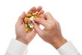 Man hand getting one pill from handful of pills, tablets, vitamins, drugs, capsules isolated on white background. White shirt, Royalty Free Stock Photo