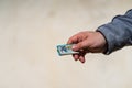 Man hand giving money like a bribe or tips. Holding EURO banknotes on a blurred background, EURO currency Royalty Free Stock Photo