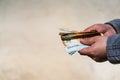 Man hand giving money like a bribe or tips. Holding EURO banknotes on a blurred background, EURO currency Royalty Free Stock Photo