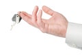 Man hand giving or offering keys isolated with clipping path Royalty Free Stock Photo