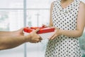 Man hand giving red gift to woman Royalty Free Stock Photo