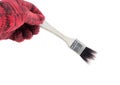 Man hand in glove holding paint brush on a white background Royalty Free Stock Photo